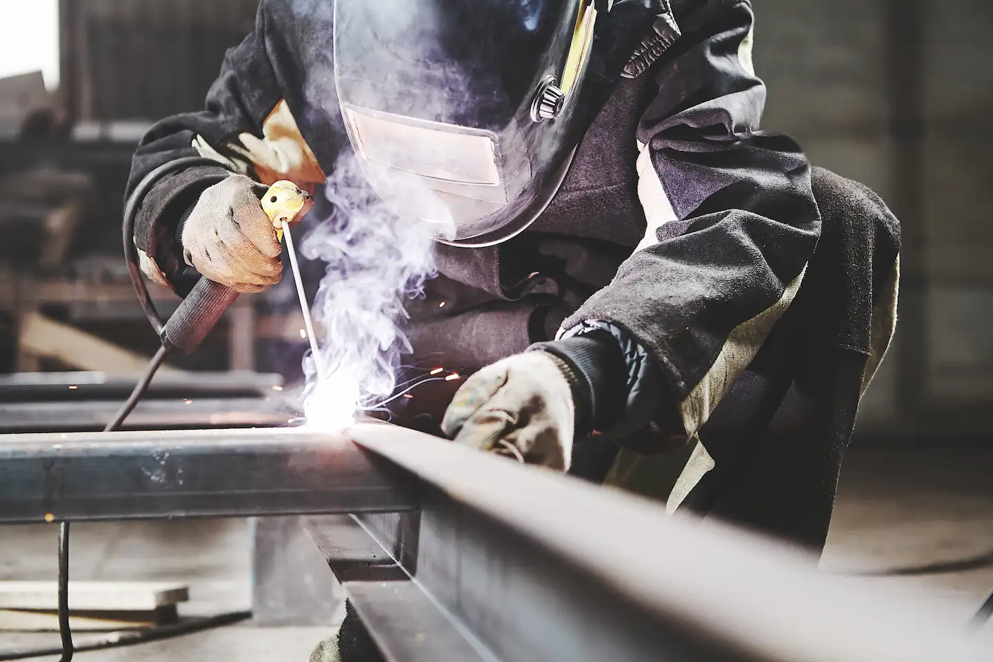 welding metal worker in protective gear